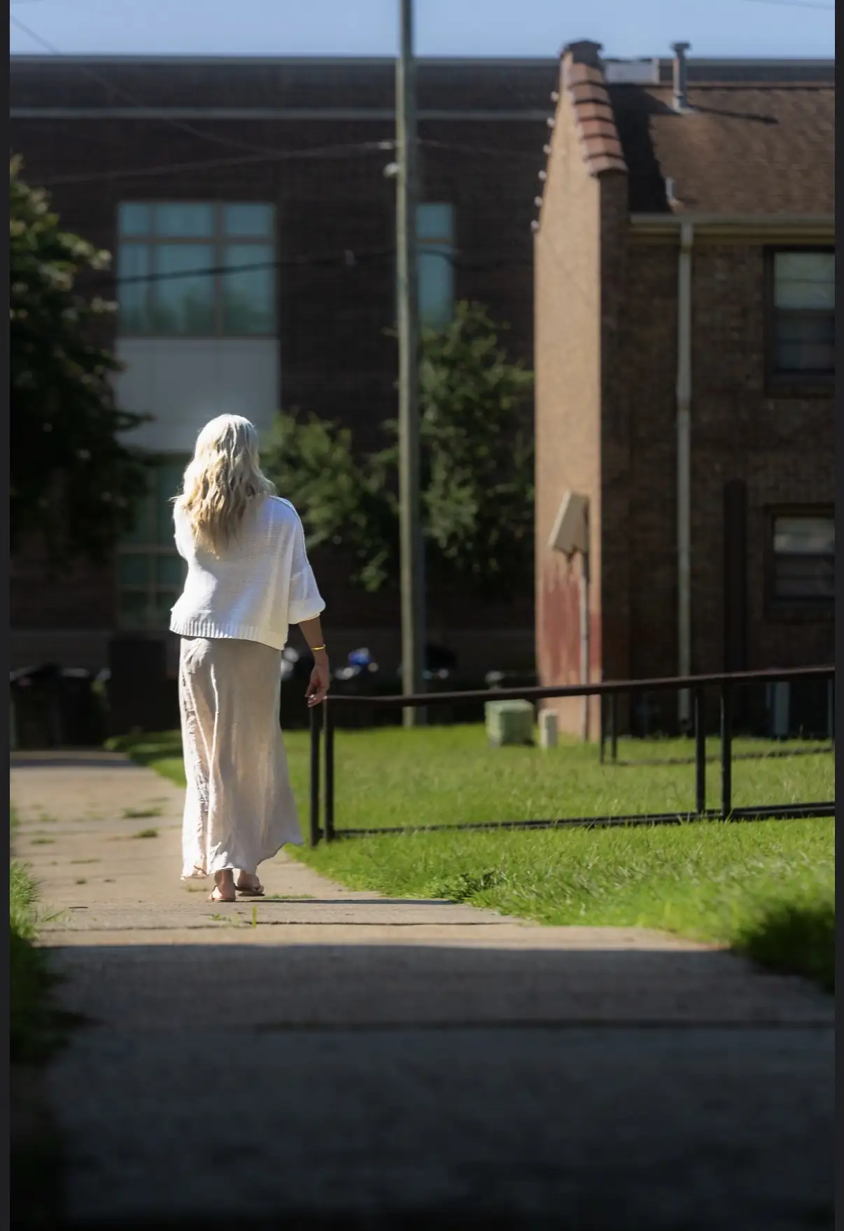 Sara walking through the neighborhood where her story began